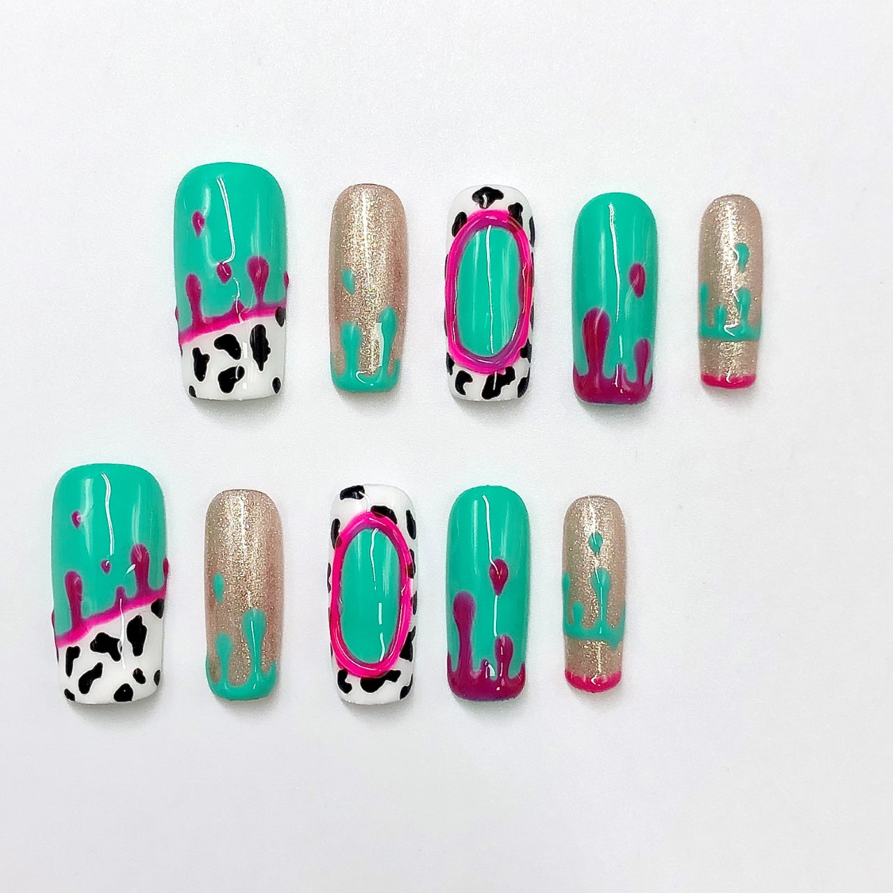 3D Emerald Green & Gold Cow Print Crystal Press-On Nails, designed for women, featuring 100% hand-pressed nails and a reusable UV-cured acrylic set with pink, red, and black-and-white cow print accents.